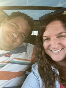Nicole and her brother smiling in a car